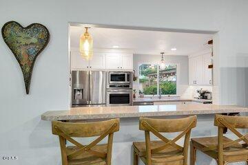 10 Rio Via Oak View, CA 93022 - Photo 8 of 19 a kitchen with stainless steel appliances granite countertop a dining table chairs and granite counter tops
