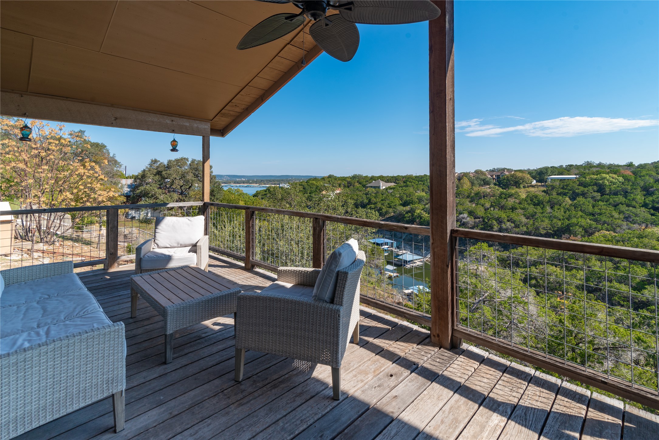 3807 Boat Dock Road Lago Vista, TX 78645 - Photo 21 of 37 A spacious covered deck with a ceiling fan offers sweeping waterfront and treelined views.