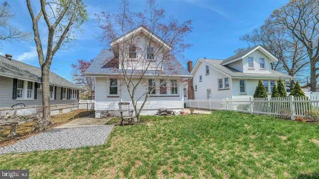 a front view of a house with a yard table and chairs
