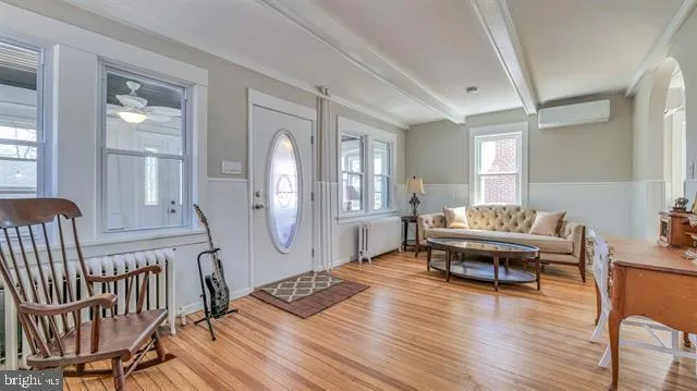 a living room with furniture and wooden floor