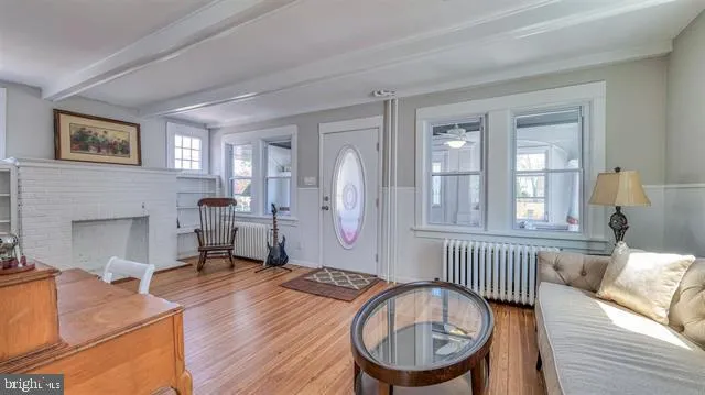 a bedroom with a bed next to a window with the dresser