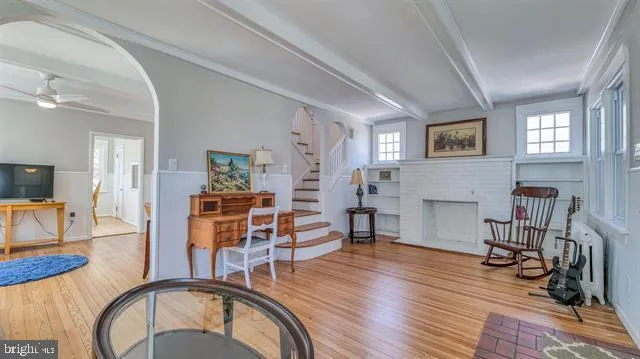 a living room with furniture a fireplace and wooden floor
