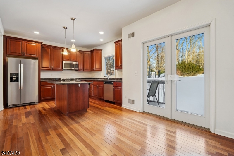 282 South Street, Unit B New Providence, NJ 07974 - Photo 13 of 28 a kitchen with stainless steel appliances granite countertop a refrigerator a stove and a wooden floors