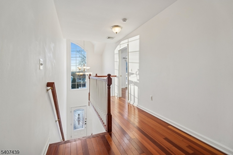 282 South Street, Unit B New Providence, NJ 07974 - Photo 14 of 28 a view of a room with wooden floor and white walls