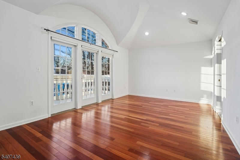 282 South Street, Unit B New Providence, NJ 07974 - Photo 16 of 28 a view of an empty room with wooden floor and a window