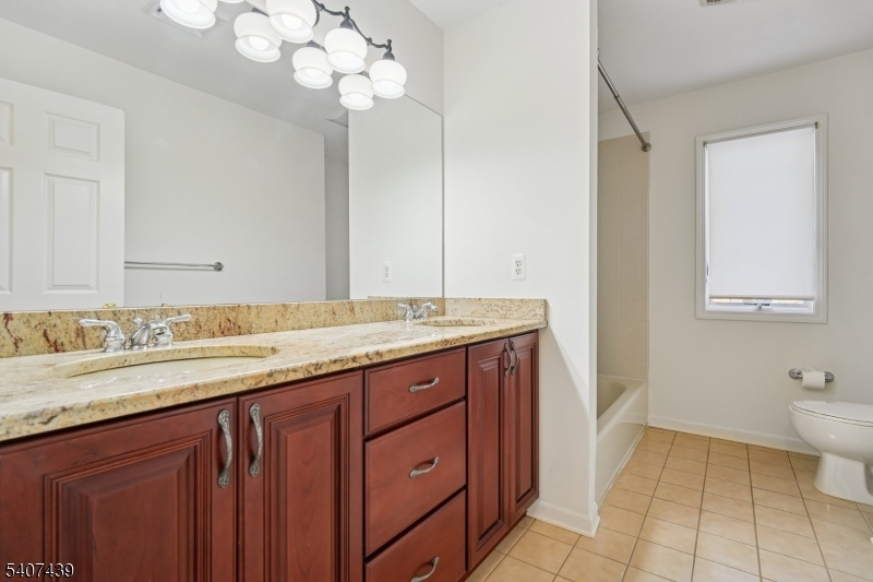 282 South Street, Unit B New Providence, NJ 07974 - Photo 19 of 28 a bathroom with a sink a vanity and a mirror