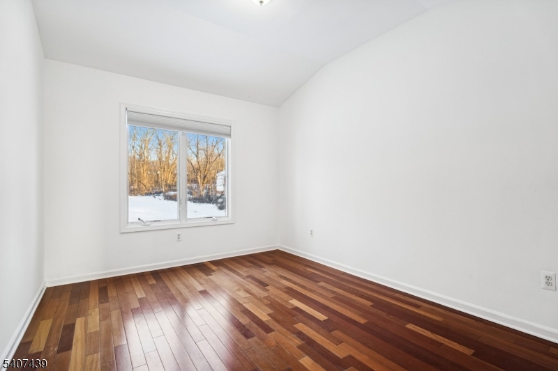 282 South Street, Unit B New Providence, NJ 07974 - Photo 23 of 28 an empty room with wooden floor and windows