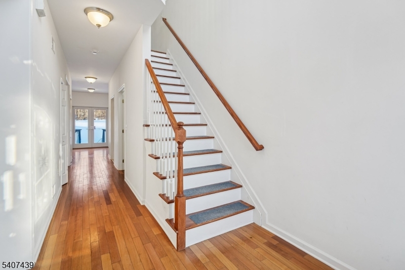 282 South Street, Unit B New Providence, NJ 07974 - Photo 4 of 28 a view of staircase with wooden floor and white walls
