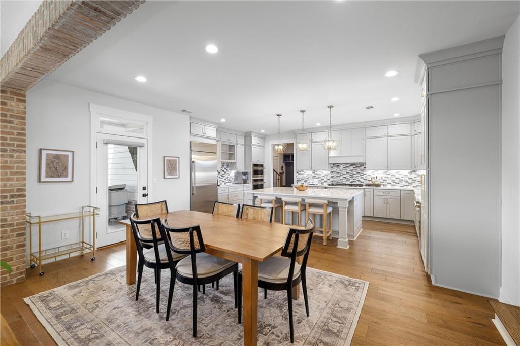 815 North Hampton Way Monroe, GA 30656 - Photo 16 of 89 a dining room with stainless steel appliances kitchen island granite countertop a dining table chairs and view kitchen
