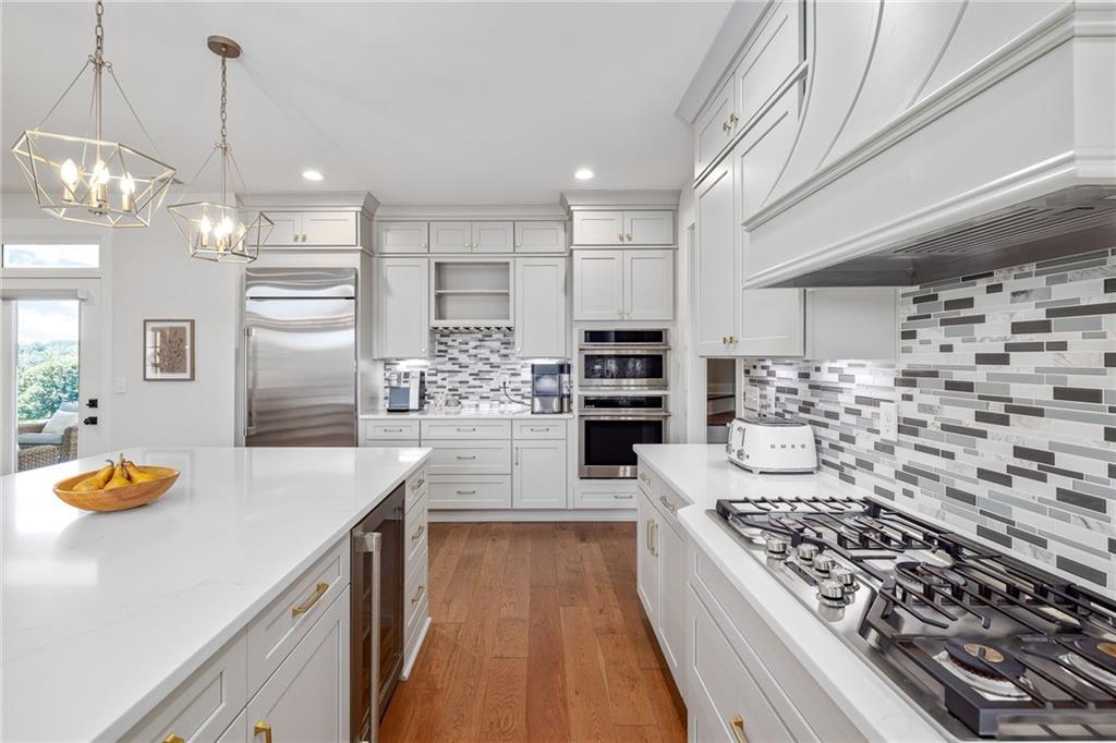 815 North Hampton Way Monroe, GA 30656 - Photo 22 of 89 a large kitchen with kitchen island granite countertop a lot of counter space and stainless steel appliances