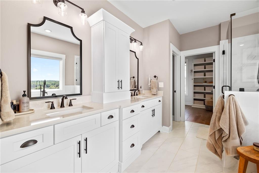 815 North Hampton Way Monroe, GA 30656 - Photo 27 of 89 a bathroom with a double vanity sink a mirror and a shower