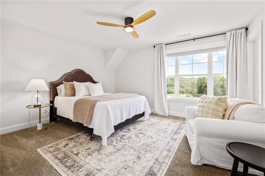 815 North Hampton Way Monroe, GA 30656 - Photo 38 of 89 a bed sitting in a bedroom next to a window