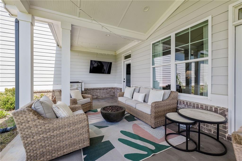 815 North Hampton Way Monroe, GA 30656 - Photo 53 of 89 a living room with furniture a flat screen tv and a large window