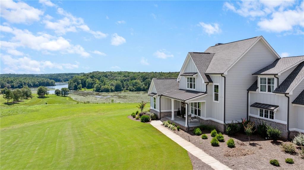 815 North Hampton Way Monroe, GA 30656 - Photo 61 of 89 a front view of a house with swimming pool having outdoor seating