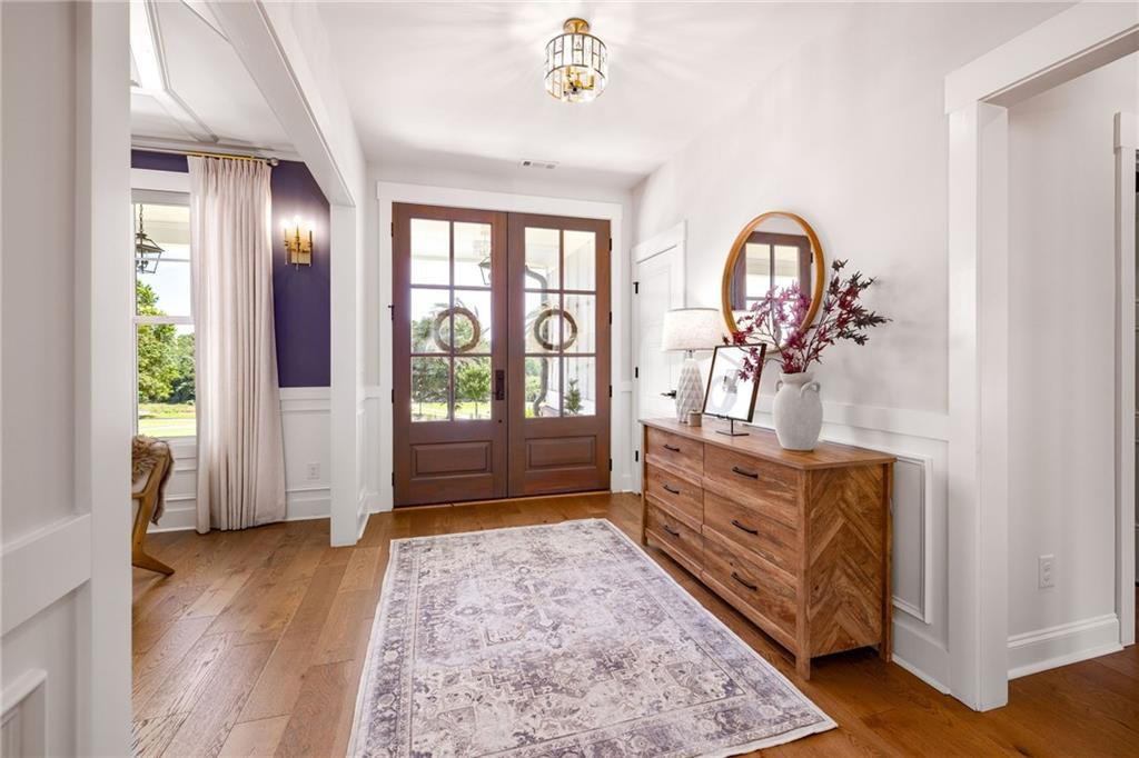 815 North Hampton Way Monroe, GA 30656 - Photo 9 of 89 a spacious bedroom with a large bed and a chandelier