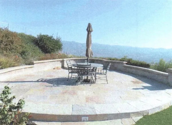 a view of a swimming pool with table and chairs