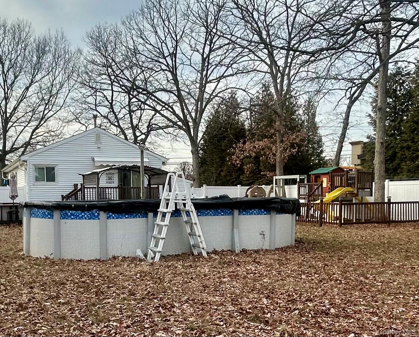 1255 Udall Road Bay Shore, NY 11706 - Photo 7 of 8 View of pool featuring a covered pool and a playground