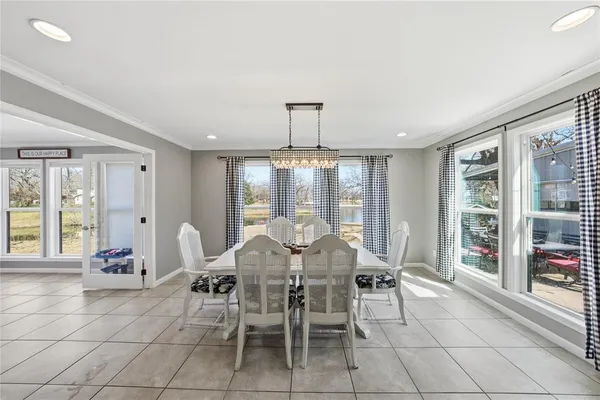 a view of a dining room with furniture and chandelier