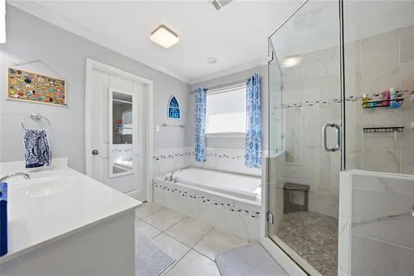 a bathroom with a tub sink shower and mirror