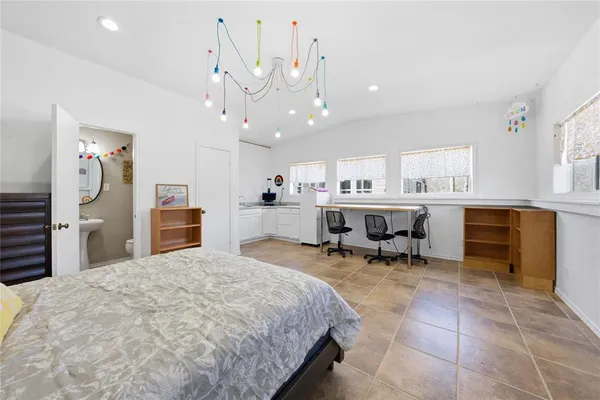 a large kitchen with a large counter space a sink stainless steel appliances and cabinets