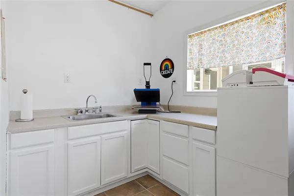 a kitchen with a sink and cabinets