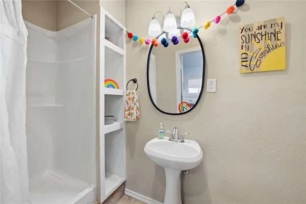 a bathroom with a sink mirror and tub