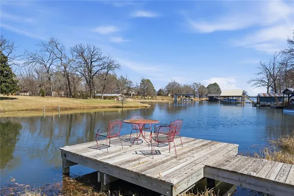 a view of a lake with furniture and city view