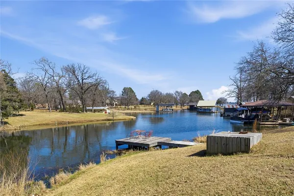 a view of a lake with boats and trees in the background