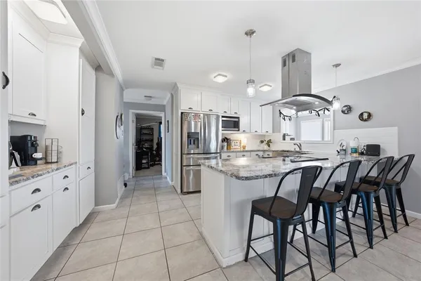 a kitchen with stainless steel appliances kitchen island granite countertop a sink and cabinets