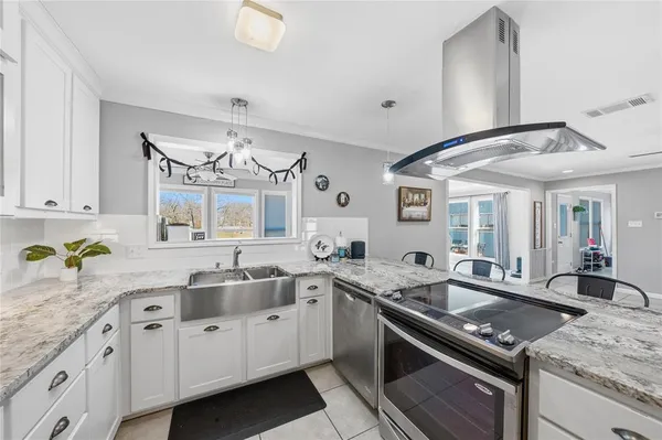 a kitchen with granite countertop a sink and stove