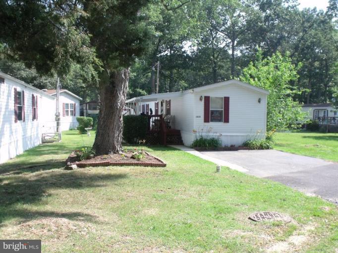 10505 Cedarville Road, Unit 1015 Brandywine, MD 20613 - Photo 1 of 26 a front view of a house with a yard and garage