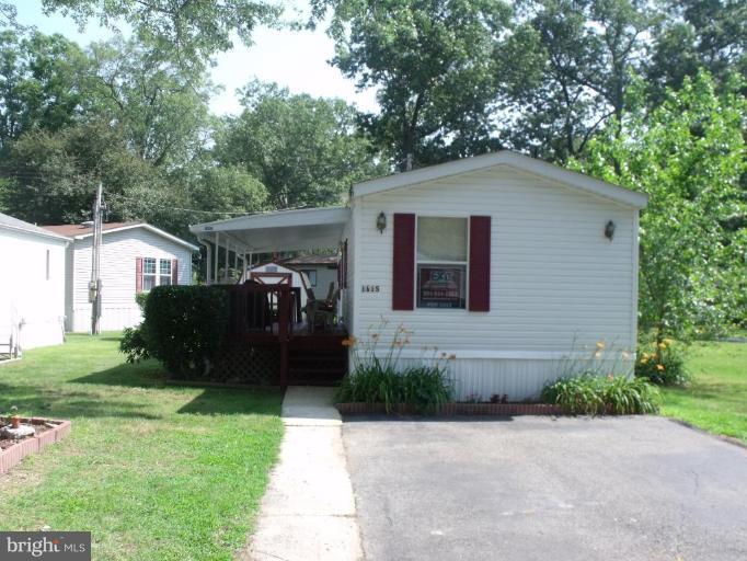 10505 Cedarville Road, Unit 1015 Brandywine, MD 20613 - Photo 2 of 26 a front view of a house with a garden