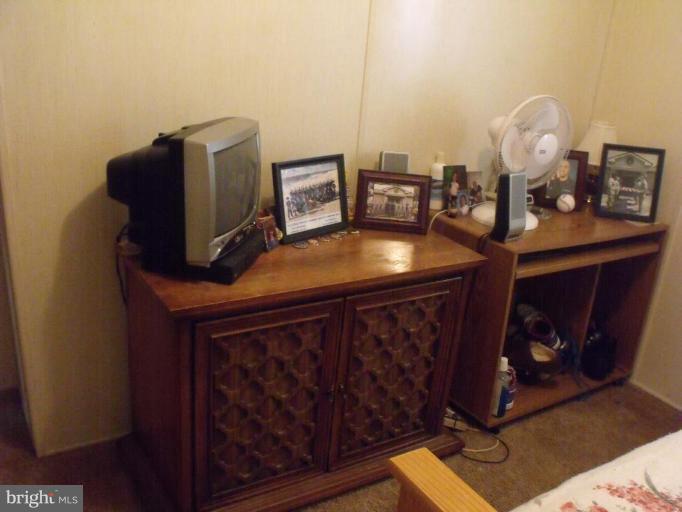 10505 Cedarville Road, Unit 1015 Brandywine, MD 20613 - Photo 18 of 26 a room with furniture and a mirror