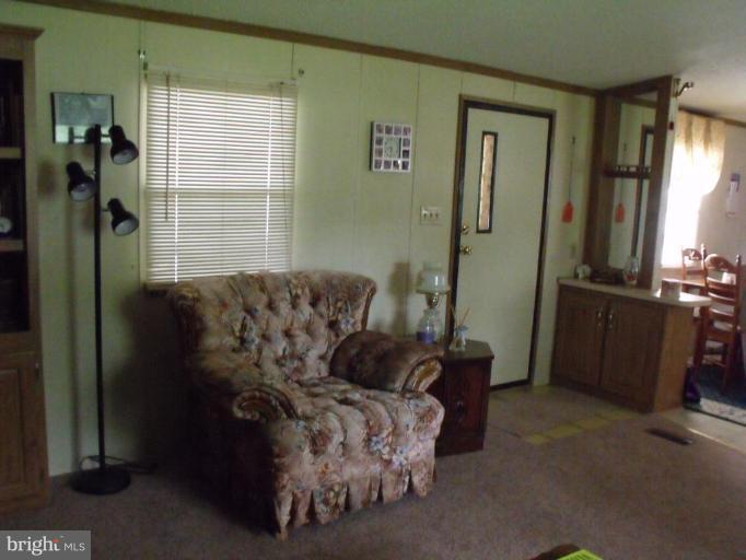 10505 Cedarville Road, Unit 1015 Brandywine, MD 20613 - Photo 22 of 26 a bed sitting in a bedroom next to a window