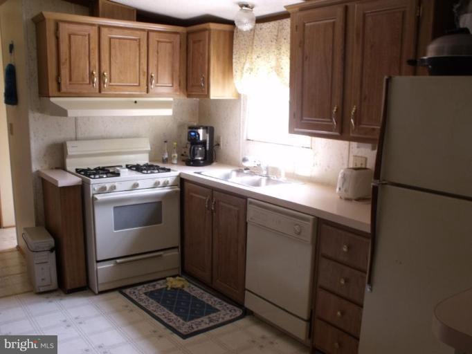 10505 Cedarville Road, Unit 1015 Brandywine, MD 20613 - Photo 8 of 26 a kitchen with a sink stove and cabinets