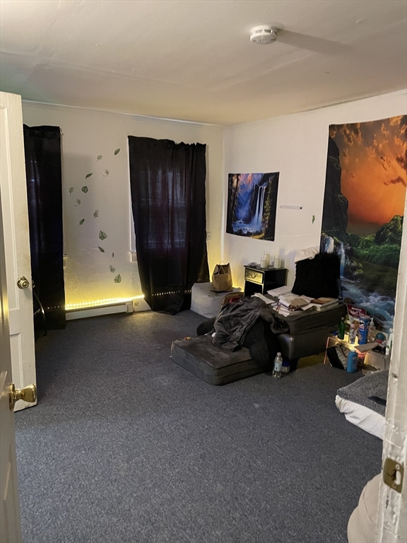 61-63 Pomona Street Springfield, MA 01108 - Photo 2 of 10 a living room with furniture and a flat screen tv
