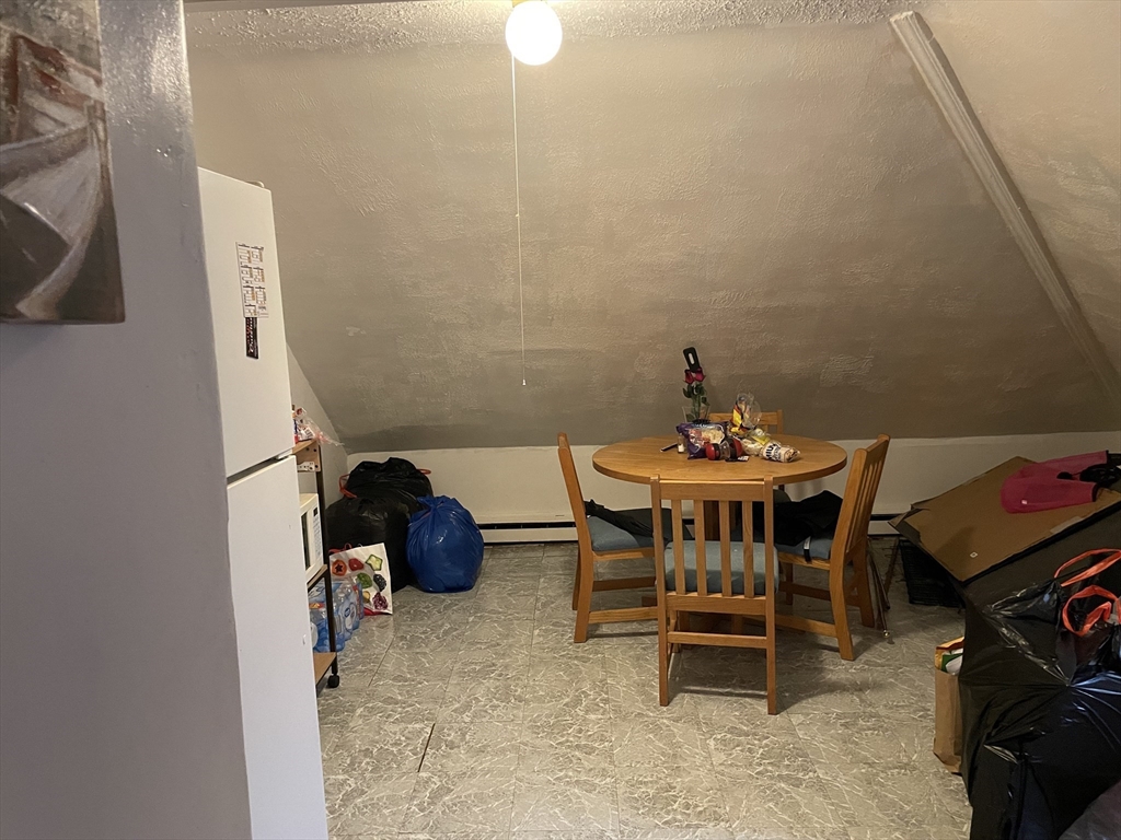 61-63 Pomona Street Springfield, MA 01108 - Photo 6 of 10 a dining room with furniture and a chandelier