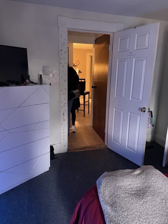 61-63 Pomona Street Springfield, MA 01108 - Photo 8 of 10 a bedroom with a bed and wooden floor