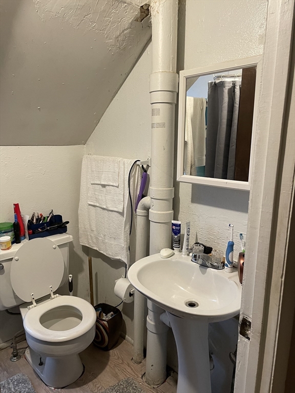 61-63 Pomona Street Springfield, MA 01108 - Photo 10 of 10 a bathroom with a sink toilet and mirror