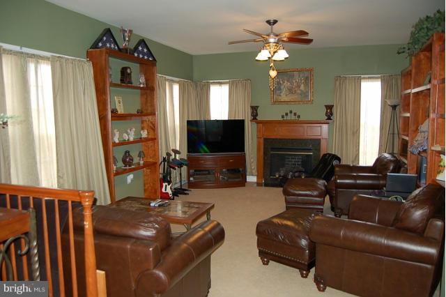 264 Rudder Road Shepherdstown, WV 25443 - Photo 5 of 30 a living room with furniture a fireplace and a flat screen tv