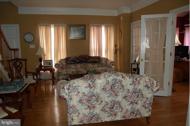 264 Rudder Road Shepherdstown, WV 25443 - Photo 7 of 30 a bedroom with a bed and wooden floor