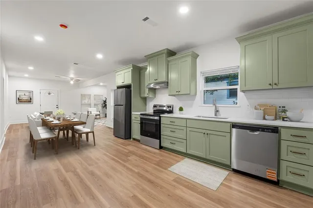 a kitchen with sink cabinets and wooden floor