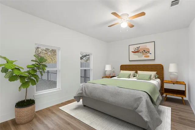 a bedroom with a bed and a potted plant