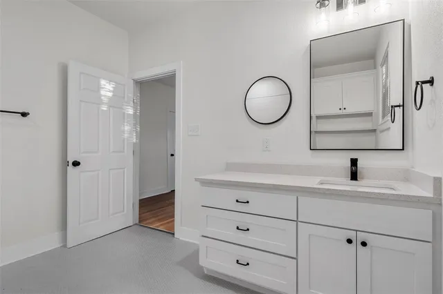 a bathroom with a double vanity sink and a mirror