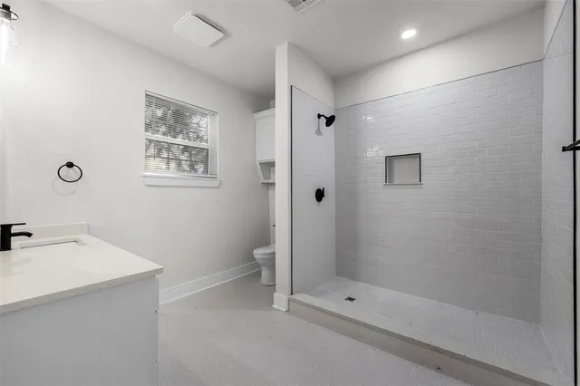 a bathroom with a toilet sink and shower