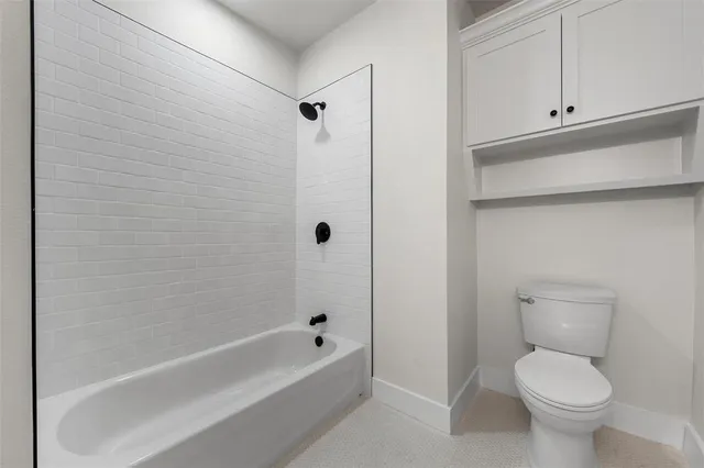 a bathroom with a toilet and a bathtub