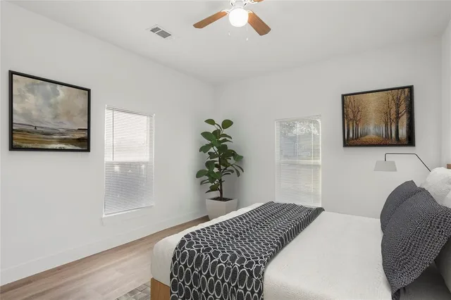 a bedroom with a bed and a painting on the wall