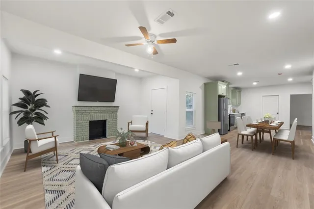 a living room with furniture a fireplace and a flat screen tv