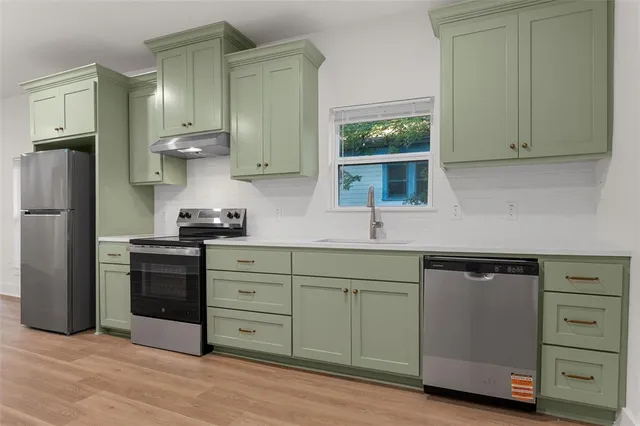 a kitchen with stainless steel appliances a stove and a refrigerator