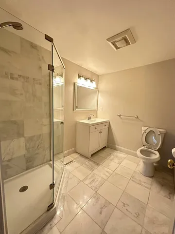 a bathroom with a sink toilet and shower